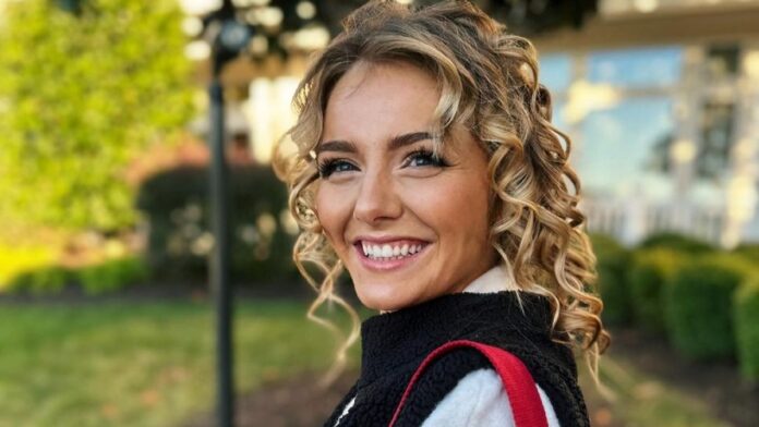 Emmy Russell pictured in curly hair smiling beautifully