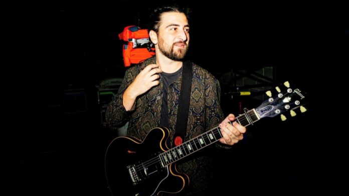Noah Kahan with his guitar